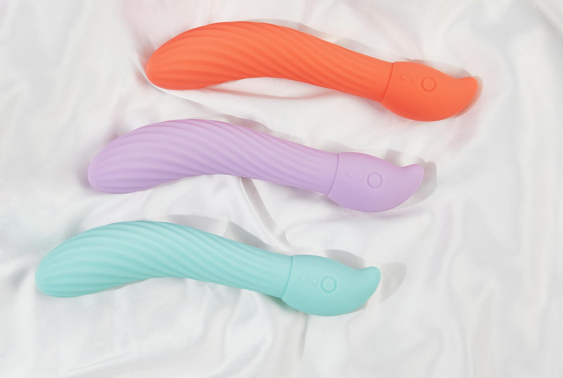 Colorful clitoral vibrators arranged on a bright yellow background, symbolizing renewed pleasure and intimacy.